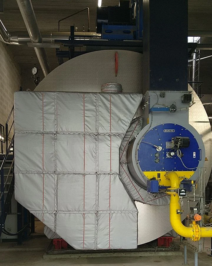 Package steam boiler with Inzonex removable insulation panels on the shell, burner front left clear